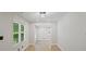 The hallway offers hardwood floors and natural light from the windows on the left at 5160 W Chapel Hill Rd, Douglasville, GA 30135