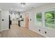 Bright kitchen with white cabinets, granite countertops, black appliances, and stylish luxury vinyl plank flooring at 5160 W Chapel Hill Rd, Douglasville, GA 30135