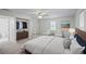 Spacious main bedroom featuring a ceiling fan, large windows, ample closet space, and an attached bathroom at 5160 W Chapel Hill Rd, Douglasville, GA 30135