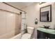 Bathroom features a shower/tub combo, tiled walls, and a vanity with a green countertop at 5273 Martins Crossing Rd, Stone Mountain, GA 30088