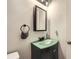 Close up of a bathroom vanity with a green countertop and modern fixtures at 5273 Martins Crossing Rd, Stone Mountain, GA 30088