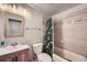 Bathroom featuring a shower/tub combo with patterned shower curtain at 5273 Martins Crossing Rd, Stone Mountain, GA 30088
