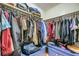 Walk-in closet with plenty of hanging space and blue storage bins at 5273 Martins Crossing Rd, Stone Mountain, GA 30088