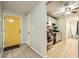 View of entryway with yellow door leading into kitchen with stainless steel appliances and tile flooring at 5273 Martins Crossing Rd, Stone Mountain, GA 30088