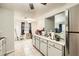 Kitchen featuring stainless steel refrigerator, white cabinets, and tile floors at 5273 Martins Crossing Rd, Stone Mountain, GA 30088