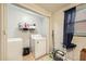 Laundry room features modern washer and dryer and storage shelves at 5273 Martins Crossing Rd, Stone Mountain, GA 30088