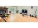 Living room with hardwood floors, stone fireplace, and entertainment center at 5273 Martins Crossing Rd, Stone Mountain, GA 30088