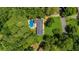 An aerial view showcasing the property's sprawling backyard, complete with a sparkling pool and mature trees at 1035 Hunterhill Dr, Roswell, GA 30075