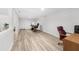Finished basement with a full workstation and wood-look flooring at 1035 Hunterhill Dr, Roswell, GA 30075