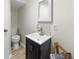 Half bathroom featuring a modern vanity and neutral walls at 1035 Hunterhill Dr, Roswell, GA 30075