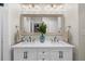Bright bathroom boasts a double sink vanity with white countertops and decorative mirror at 1035 Hunterhill Dr, Roswell, GA 30075