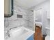 Updated bathroom with walk in shower, marble wall tiles, and modern fixtures at 1035 Hunterhill Dr, Roswell, GA 30075