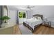 Cozy bedroom with a light blue color scheme and hardwood floors and backyard view at 1035 Hunterhill Dr, Roswell, GA 30075