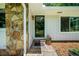 Close-up showcasing the front entrance with stone accents, welcome mat, and potted plants at 1035 Hunterhill Dr, Roswell, GA 30075