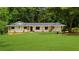 Ranch-style home showcasing its well-maintained lawn, stone accents, and inviting curb appeal at 1035 Hunterhill Dr, Roswell, GA 30075