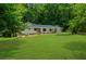 Ranch-style home showcasing its well-maintained lawn, stone accents, and inviting curb appeal at 1035 Hunterhill Dr, Roswell, GA 30075