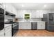 Bright kitchen with white cabinets, stainless steel appliances, and plenty of counter space at 1035 Hunterhill Dr, Roswell, GA 30075