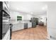 Spacious kitchen with white cabinets, stainless steel appliances, and views into dining area at 1035 Hunterhill Dr, Roswell, GA 30075
