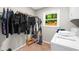 Convenient laundry room equipped with washer, dryer, storage and natural light from the window at 1035 Hunterhill Dr, Roswell, GA 30075