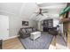 Comfortable living room features a fireplace, skylight, ceiling fan, and comfortable furniture and decorative rug at 1035 Hunterhill Dr, Roswell, GA 30075