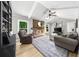 Cozy living room with fireplace, skylight, ceiling fan, comfortable furniture and a decorative rug at 1035 Hunterhill Dr, Roswell, GA 30075