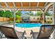 View from under the pergola, capturing a refreshing pool area perfect for summer relaxation and outdoor entertaining at 1035 Hunterhill Dr, Roswell, GA 30075