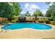 Wide shot of the in-ground pool in the backyard and the back of the house at 1035 Hunterhill Dr, Roswell, GA 30075