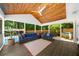 Spacious screened porch with wood ceiling, ceiling fan, with comfortable furniture and access to pool at 1035 Hunterhill Dr, Roswell, GA 30075