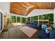 Spacious screened porch with wood ceiling, ceiling fan, comfortable seating, and access to pool at 1035 Hunterhill Dr, Roswell, GA 30075