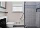 Bathroom boasting a tiled shower with gray pebble flooring and black cabinets at 2473 Melinda Ne Dr, Atlanta, GA 30345