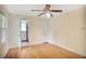 Bright bedroom featuring hardwood floors, a ceiling fan, and a convenient ensuite bathroom at 2473 Melinda Ne Dr, Atlanta, GA 30345