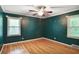 Bedroom boasting hardwood floors, ample light from two windows, and a ceiling fan fixture at 2473 Melinda Ne Dr, Atlanta, GA 30345