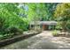 Charming brick home with a beautiful driveway surrounded by mature trees and lush landscaping at 2473 Melinda Ne Dr, Atlanta, GA 30345