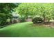 Charming brick home with well-manicured front lawn and mature trees offering shade and curb appeal at 2473 Melinda Ne Dr, Atlanta, GA 30345