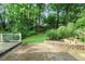 Concrete backyard patio and terraced garden area surrounded by trees and greenery at 2473 Melinda Ne Dr, Atlanta, GA 30345
