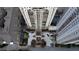 Stunning aerial view of the high-rise condo building showcasing the entrance, landscaping, and surrounding buildings at 795 Hammond Dr # 506, Sandy Springs, GA 30328