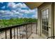Balcony with railing overlooking a lush green landscape and parking area below at 795 Hammond Dr # 506, Sandy Springs, GA 30328