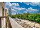 Balcony showcasing a view of a tree-filled landscape, with parking and buildings at 795 Hammond Dr # 506, Sandy Springs, GA 30328