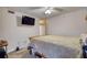 Bedroom features neutral walls, carpet, and a large bed with a wall-mounted TV at 795 Hammond Dr # 506, Sandy Springs, GA 30328