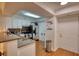Bright kitchen with stainless steel appliances, white cabinets, granite countertops, and a door to the hallway at 795 Hammond Dr # 506, Sandy Springs, GA 30328