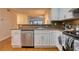 View of the kitchen with stainless steel dishwasher, white cabinets, and granite countertops at 795 Hammond Dr # 506, Sandy Springs, GA 30328