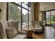 Lounge area featuring comfortable armchairs, hardwood floors, and natural light from large windows at 795 Hammond Dr # 506, Sandy Springs, GA 30328