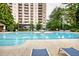 Exterior shot of the pool area and high-rise building featuring several lounge chairs at 795 Hammond Dr # 506, Sandy Springs, GA 30328
