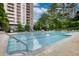 Outdoor pool with lounge chairs and well-maintained grounds at this complex at 795 Hammond Dr # 506, Sandy Springs, GA 30328
