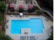 Overhead view of the expansive swimming pool, surrounded by lounge chairs and cabanas at 795 Hammond Dr # 506, Sandy Springs, GA 30328