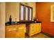 The charming wet bar features a sink, granite countertop, light-colored cabinetry, and a decorative window at 795 Hammond Dr # 506, Sandy Springs, GA 30328