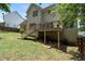 Back exterior showcasing a deck, patio, and well-maintained yard at 2167 Merrymount Dr, Suwanee, GA 30024