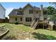 Two-story home featuring a backyard with a deck, patio, and stone pathway at 2167 Merrymount Dr, Suwanee, GA 30024