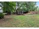 Spacious backyard with a hammock, patio, and lush green landscaping at 2167 Merrymount Dr, Suwanee, GA 30024