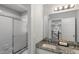 Bathroom featuring a granite countertop, large mirror and sliding glass shower doors at 2167 Merrymount Dr, Suwanee, GA 30024